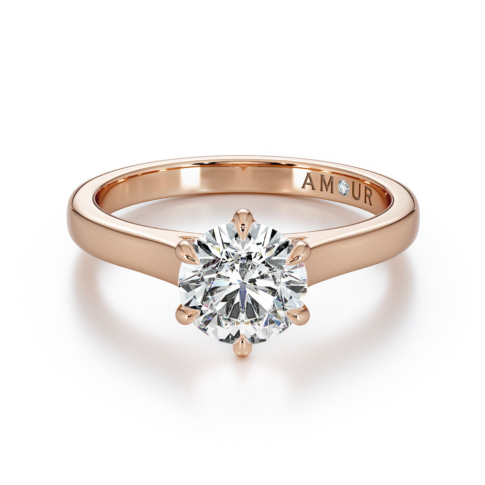 Brilliant cut six claw solitaire with cathedral shoulders