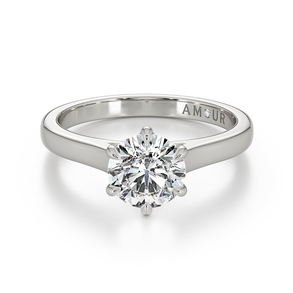 Brilliant cut six claw solitaire with cathedral shoulders