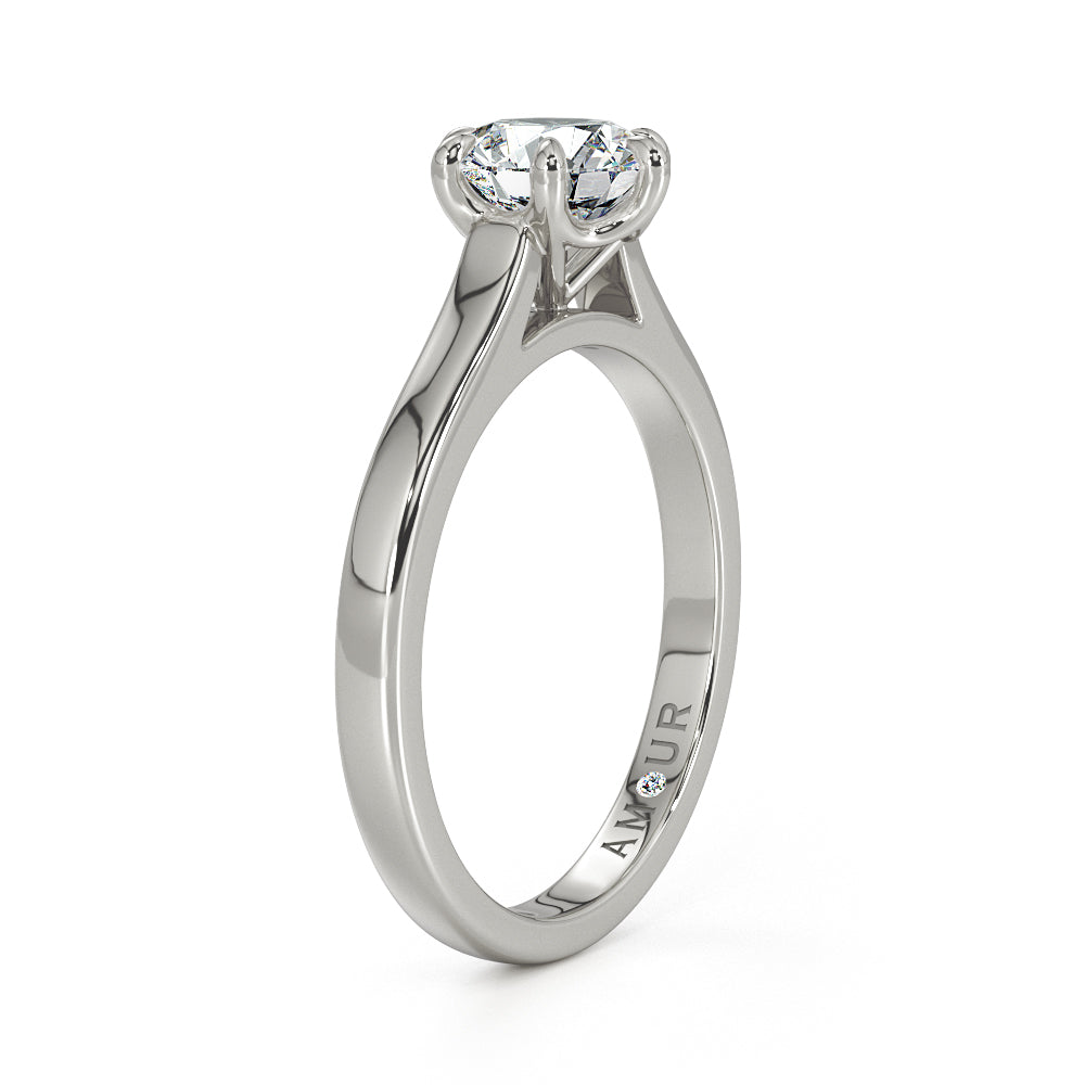 Brilliant cut six claw solitaire with cathedral shoulders