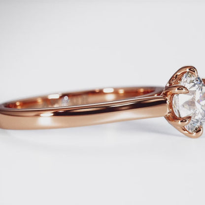 Brilliant cut six claw solitaire with cathedral shoulders